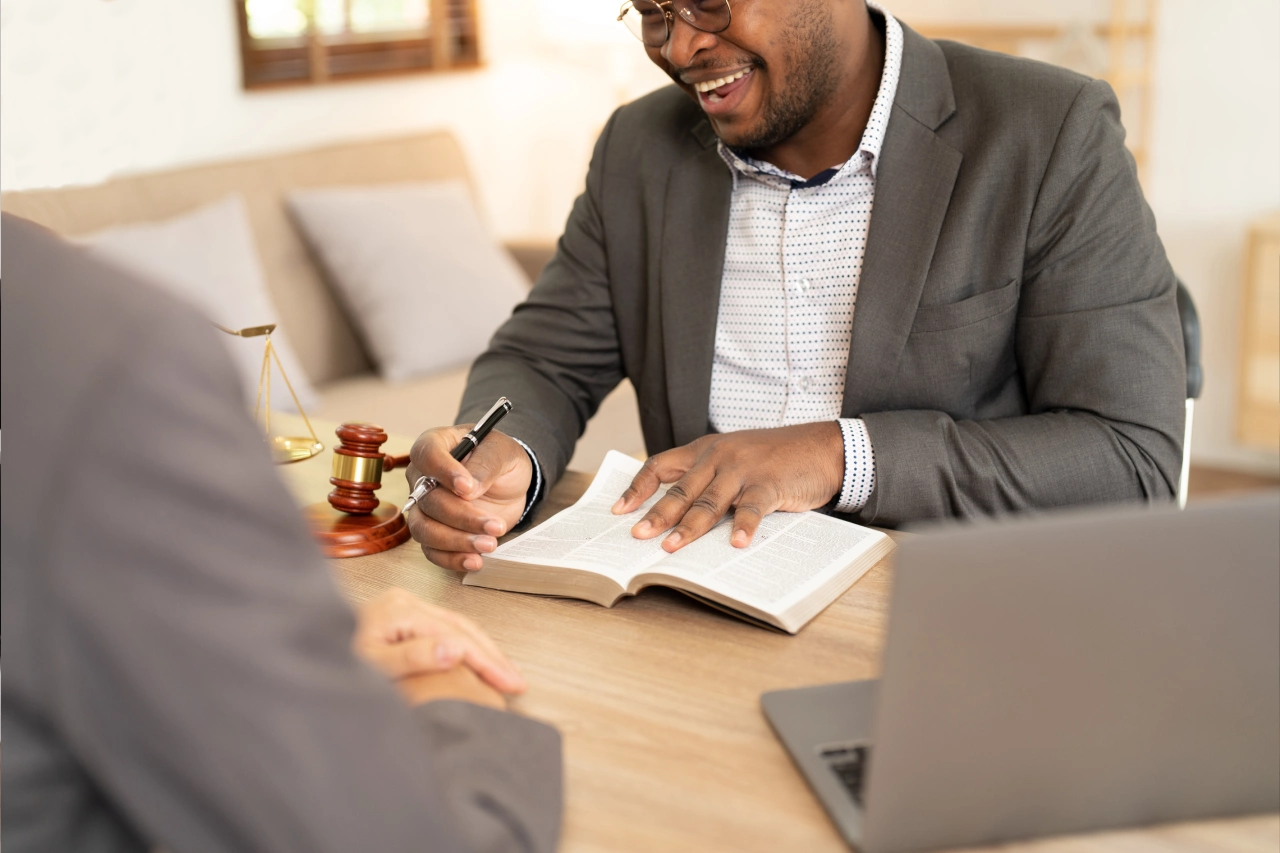 A man in suit and tie writing on paper.