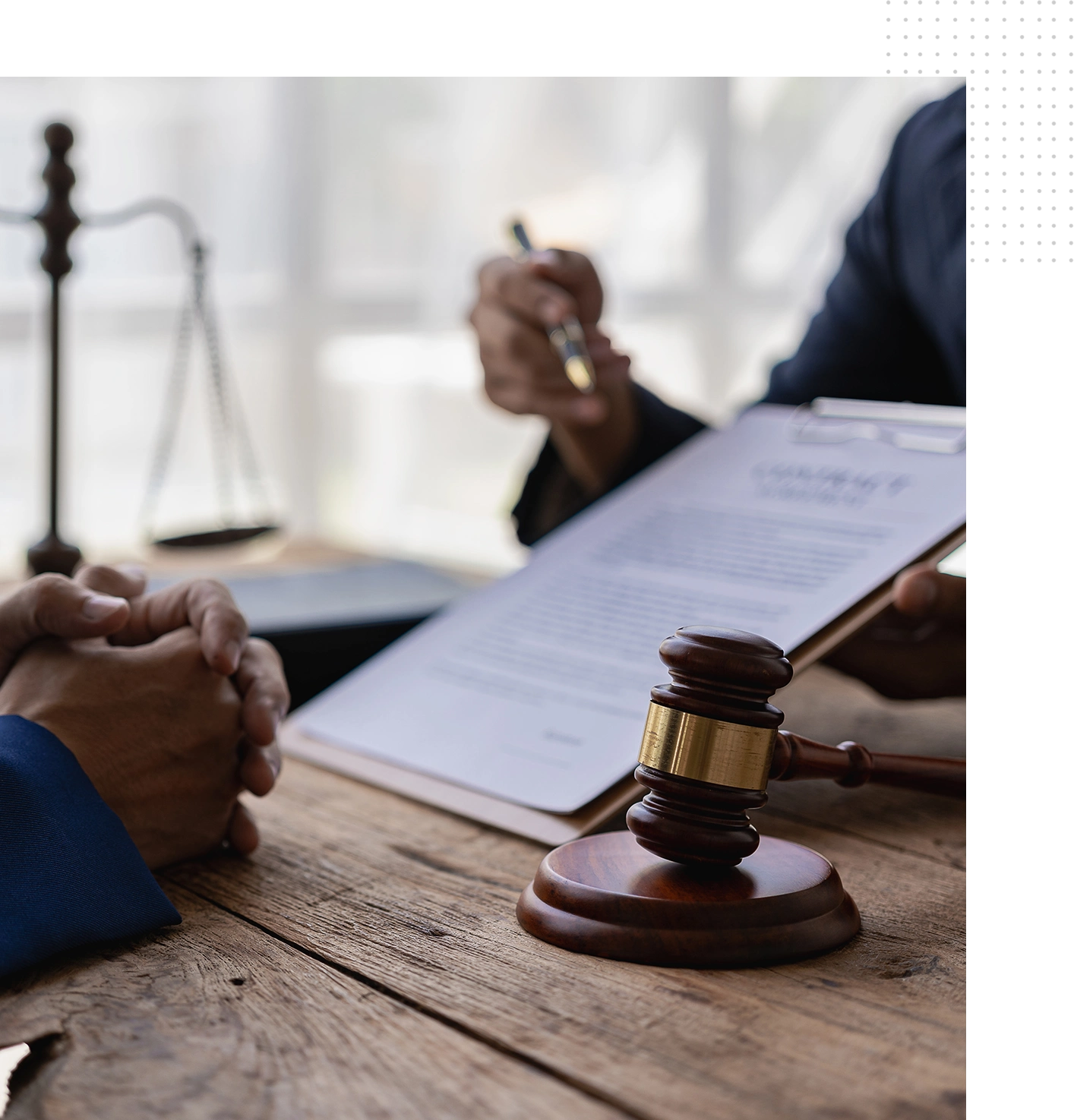 A judge sitting at the table with two people.